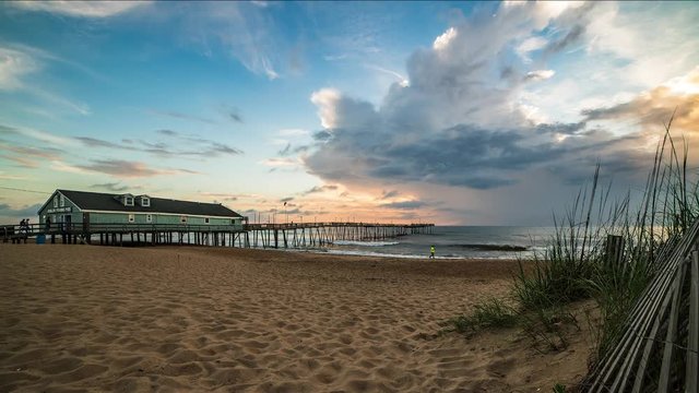 Timelapse of bright sunrise over Avalon Pier in North Carolina Outer Banks