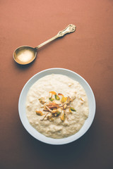 Sweet Rabdi or Lachha Rabri or basundi, made with pure milk garnished with dry fruits. Served in a bowl over moody background. Selective focus