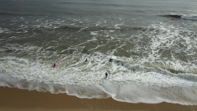 Surfers on the beach of Belmar ready to go in the water.