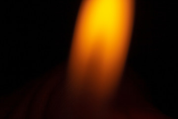 An orange isolated flame on a black background