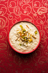 Sweet Rabdi or Lachha Rabri or basundi, made with pure milk garnished with dry fruits. Served in a bowl over moody background. Selective focus