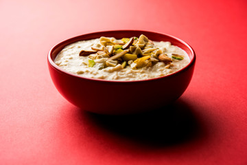 Sweet Rabdi or Lachha Rabri or basundi, made with pure milk garnished with dry fruits. Served in a bowl over moody background. Selective focus