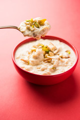 Sweet Rabdi or Lachha Rabri or basundi, made with pure milk garnished with dry fruits. Served in a bowl over moody background. Selective focus