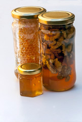 Honey with nuts surrounded by white background