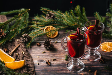 Mug of christmas mulled wine with spices and orange slices on rustic table. Traditional drink on...