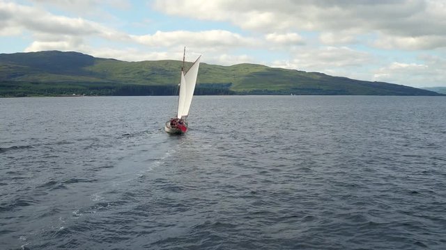 Beautiful aerial shot of an old gaff ketch sailing in the Sound of Mull