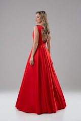 Pretty blonde in luxurious red evening dress shot