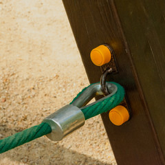 Thimble. Detail of fixing the blue nylon rope to the wooden beam on the structures of the...