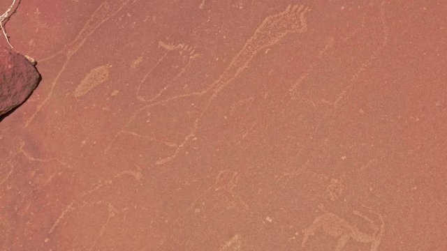 Rock carvings of giraffes and other animals in Twyfelfontein, Namibia, TILT DOWN