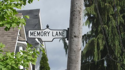 Memory lane street sign with rooftops and trees in Toronto, Canada.