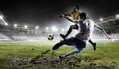 Obraz na płótnie Canvas Soccer players at stadium. Mixed media