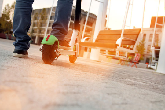 Close up image of a man on an electric scooter.