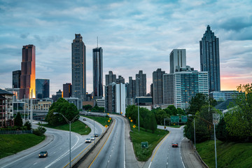 Calm roads flowing against city skyline right after sunset, summer evening. Atlanta, USA.