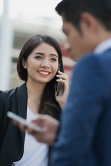 Smiling Business woman talking on the mobile phone, mobile phone in hand.