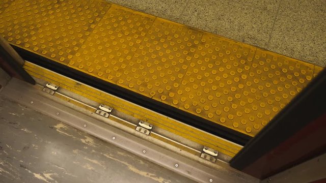 Passenger pov view of yellow platform and red subway car door closing. Toronto, Ontario, Canada.