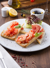 Italian sandwiches with tomatoes, shrimps and prsciutto bacon