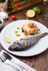 Grilled dorado fish served with vegetable salad