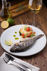 Grilled dorado fish served with vegetable salad