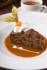 Slice of chocolate cake served with cupt tea and mint