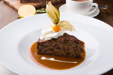 Slice of chocolate cake served with cupt tea and mint