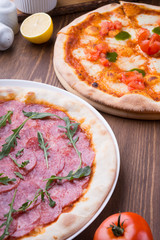 Two different pizzas freshly baked