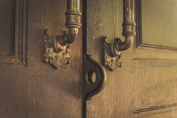 Old wooden door with lock for keys.