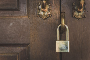 Old wooden door with lock for key with silver.