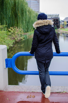 girl in warm clothes on the bridge