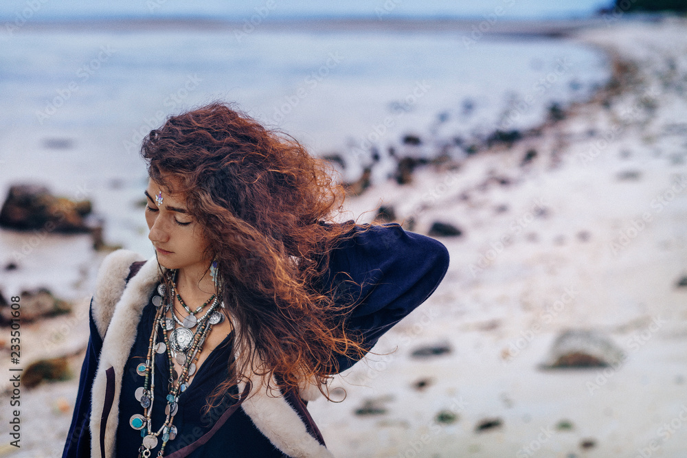 Wall mural stylish young fashionable woman walking on the beach at sunset