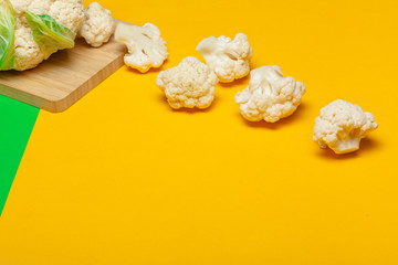 Cauliflower pieces on a bright yellow background
