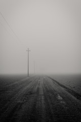 Gravel road in the fog in winter Italy