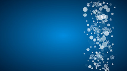 Snowflakes falling on blue background. Christmas and New Year horizontal theme. Frosty falling snowflakes for banners, gift card, party invitation, compliments and special business offer