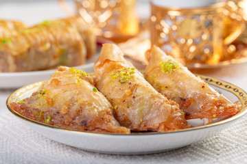 Turkish traditional Dessert Baklava with tea on dark background. Fresh and healthy dessert.