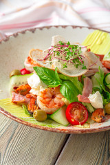 Fresh seafood salad served with prawns and greens