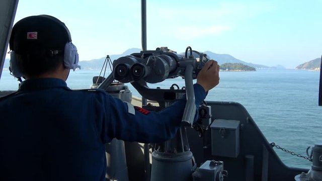 A crew looking through binoculars on the ship, 4K