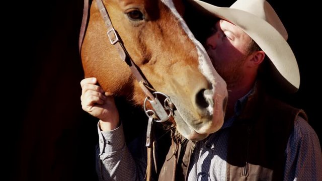 Cowboy Ranch hand with horse on Dude Ranch in Corral USA