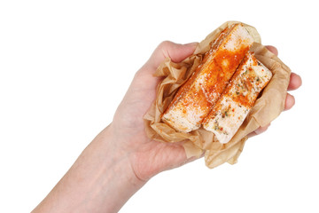 Old country rural man holds pieces of salted pork lard with spices in his hand. Isolated