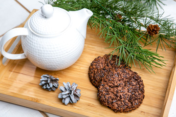 Delicious cookies with chocolate crumbs. Tasty dessert food in close up. Chocolate cookies served on tray, decorated fir branches. French cuisine. Christmas theme