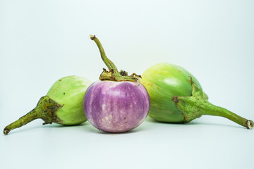 Withered eggplant with shrunken skin on white background