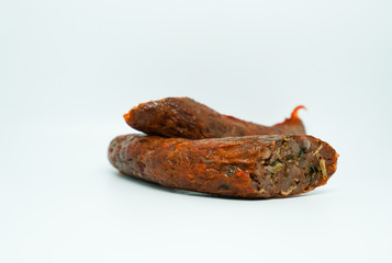 Sai ua or northern Thai sausage or Chiang Mai sausage is a grilled pork sausage from northern Thailand on white background.