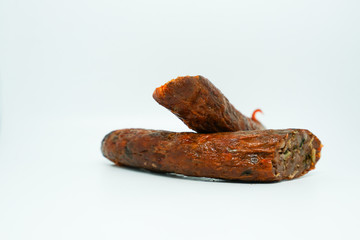 Sai ua or northern Thai sausage or Chiang Mai sausage is a grilled pork sausage from northern Thailand on white background.