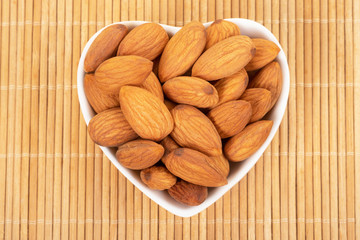 Almonds on wooden background. Healty food concept.