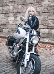 Plakat Beautiful biker woman with motorcycle. 