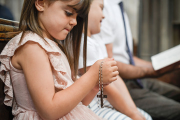 Little catholic girl praying with a rosary in her hands - Powered by Adobe