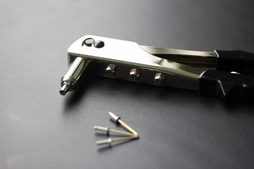 Detail of an old rivet gun (hand riveter) with rivets 