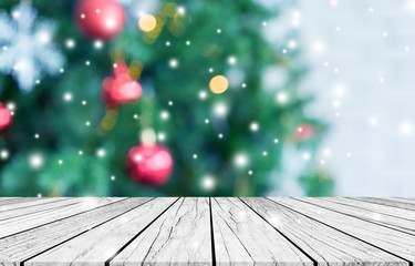 abstract blurry beautiful of decoration Christmas tree with blink snowfall background and plank...