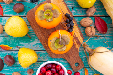Autumn harvest, fruits and autumn vegetables on a wooden background. 