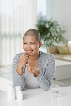 Cancer survivor taking pills