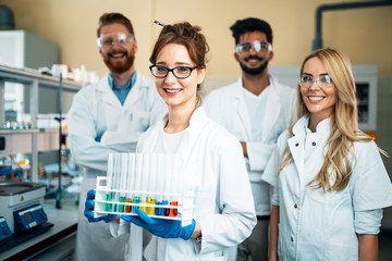 Group of young successful scientists posing for camera