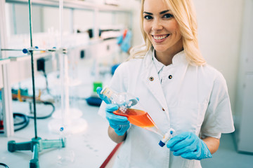 Fototapeta premium Attractive student of chemistry working in laboratory